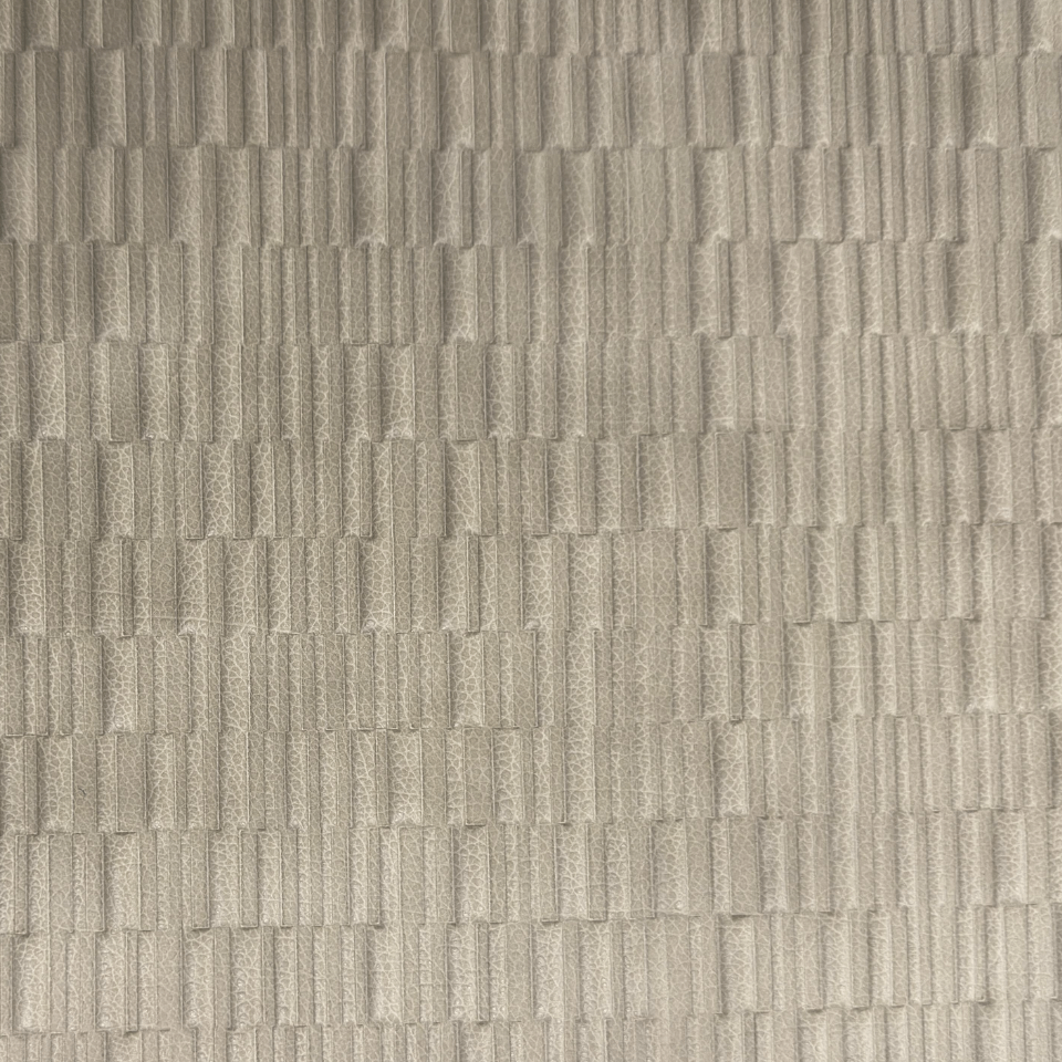 Structured grid leather with clean geometry for contemporary interior use.